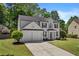 Desirable home with a two-car garage, lush lawn, and traditional curb appeal in a Gathering-friendly neighborhood at 4680 Glen Level Dr, Sugar Hill, GA 30518