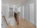 Hallway with railing, lighting, and doors at 4680 Glen Level Dr, Sugar Hill, GA 30518