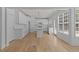 Open concept kitchen with white cabinets, island, and hardwood floors at 4680 Glen Level Dr, Sugar Hill, GA 30518