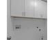 The laundry room features built-in cabinetry with white walls at 4680 Glen Level Dr, Sugar Hill, GA 30518