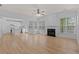 Open living room with hardwood floors, fireplace, and seamless flow to the modern kitchen at 4680 Glen Level Dr, Sugar Hill, GA 30518