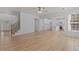 Expansive living room flows into a modern kitchen and features beautiful hardwood floors at 4680 Glen Level Dr, Sugar Hill, GA 30518