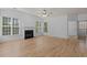 Bright living room with hardwood floors, fireplace, and large windows for ample natural light at 4680 Glen Level Dr, Sugar Hill, GA 30518