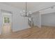 Versatile room with gleaming hardwood floors, stylish lighting, and flexible space for a variety of uses at 4680 Glen Level Dr, Sugar Hill, GA 30518