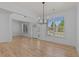 Spacious living area boasting hardwood floors, contemporary lighting, and abundant natural light at 4680 Glen Level Dr, Sugar Hill, GA 30518