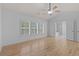 This spacious main bedroom features a tray ceiling with a ceiling fan and three windows for natural light at 4680 Glen Level Dr, Sugar Hill, GA 30518