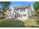 Exterior of the house featuring a well-manicured lawn and a cozy patio for outdoor relaxation at 4680 Glen Level Dr, Sugar Hill, GA 30518