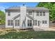 Rear exterior with large windows, patio, and well-maintained lawn showcasing the property's outdoor space at 4680 Glen Level Dr, Sugar Hill, GA 30518