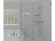 This modern shower features a seamless glass door, white subway tile, and built-in shelving at 4680 Glen Level Dr, Sugar Hill, GA 30518