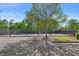Outdoor tennis courts in a landscaped community with benches, lighting, and a parking area at 4680 Glen Level Dr, Sugar Hill, GA 30518