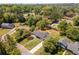 Aerial view of a landscaped property with mature trees in a neighborhood with city skyline in the distance at 5036 Chestnut Forest Ln, Dunwoody, GA 30360
