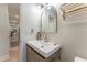 Modern bathroom vanity with neutral colors and a gold mirror and fixtures at 5036 Chestnut Forest Ln, Dunwoody, GA 30360