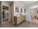 Bright bathroom with a wood vanity, modern fixtures, and a walk-in shower at 5036 Chestnut Forest Ln, Dunwoody, GA 30360
