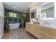 Modern bathroom with dual vanity, soaking tub, walk-in shower, and luxurious finishes throughout at 5036 Chestnut Forest Ln, Dunwoody, GA 30360