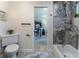 Elegant bathroom showcasing marble tile, tub, and doorway view of the office space at 5036 Chestnut Forest Ln, Dunwoody, GA 30360