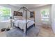 Bright bedroom with a four poster bed, light walls and multiple windows at 5036 Chestnut Forest Ln, Dunwoody, GA 30360