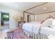Bright bedroom featuring a canopy bed, hardwood floors, and ensuite bathroom in view at 5036 Chestnut Forest Ln, Dunwoody, GA 30360