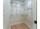 Empty walk-in closet features custom shelving and hardwood floors, ready to be filled at 5036 Chestnut Forest Ln, Dunwoody, GA 30360