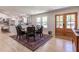 Open concept dining area showcasing wood floors and the seamless flow to the modern kitchen at 5036 Chestnut Forest Ln, Dunwoody, GA 30360