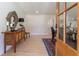 Welcoming entryway featuring a wooden console table, decorative mirror, and hardwood floors at 5036 Chestnut Forest Ln, Dunwoody, GA 30360