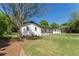 Charming home with a well-manicured lawn, white painted brick, and a stepping stone walkway at 5036 Chestnut Forest Ln, Dunwoody, GA 30360