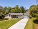 Beautifully landscaped with a concrete driveway leading to an attached garage at 5036 Chestnut Forest Ln, Dunwoody, GA 30360