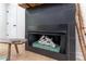 Close-up of a modern tiled fireplace, with wooden logs set inside of the firebox, and birch sticks at 5036 Chestnut Forest Ln, Dunwoody, GA 30360