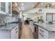 Well-appointed kitchen featuring stainless steel appliances, granite countertops, and bar seating with an open floor plan at 5036 Chestnut Forest Ln, Dunwoody, GA 30360