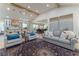Open concept living room boasts beamed ceilings, hardwood floors, and seamless connection to a modern kitchen at 5036 Chestnut Forest Ln, Dunwoody, GA 30360