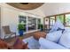 Inviting screened porch transitions to the living room with comfortable seating and views of backyard greenery at 5036 Chestnut Forest Ln, Dunwoody, GA 30360