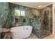 Spa bathroom showcasing an inviting tub, glass shower enclosure, and elegant marble-style tiling at 5036 Chestnut Forest Ln, Dunwoody, GA 30360