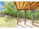 View of the backyard with the base of a wood deck and mature trees at 6252 Shenfield Ln, Union City, GA 30291