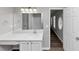 Bathroom featuring large mirrors, single sink, and a view to a unique oval window at 6252 Shenfield Ln, Union City, GA 30291