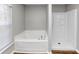 Bathroom featuring large tub and separate shower at 6252 Shenfield Ln, Union City, GA 30291