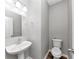 A half bathroom with a pedestal sink, and toilet at 6252 Shenfield Ln, Union City, GA 30291