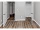 A bedroom with open doors showing the light gray walls and wood-look flooring at 6252 Shenfield Ln, Union City, GA 30291