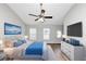Bright bedroom featuring wood floors, ceiling fan, unique window, with modern furniture at 6252 Shenfield Ln, Union City, GA 30291