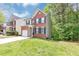 Charming two-story brick home with a well-maintained lawn and attached garage at 6252 Shenfield Ln, Union City, GA 30291