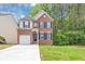 Charming two-story brick home with a well-maintained lawn and attached garage at 6252 Shenfield Ln, Union City, GA 30291