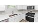 Bright kitchen features white cabinets, stainless appliances, new countertops and flooring at 6252 Shenfield Ln, Union City, GA 30291