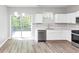 Bright kitchen features white cabinets, stainless appliances and an adjacent deck at 6252 Shenfield Ln, Union City, GA 30291
