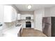 Bright kitchen features white cabinets, stainless appliances, new countertops and flooring at 6252 Shenfield Ln, Union City, GA 30291