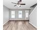 Bright living room features new gray paint, a ceiling fan and beautiful laminate flooring at 6252 Shenfield Ln, Union City, GA 30291