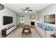 Bright living room features new gray paint, a fireplace and beautiful laminate flooring at 6252 Shenfield Ln, Union City, GA 30291