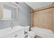 Full bathroom with shower and bathtub combo, tiled walls and grey vanity at 628 Warren Ave, Scottdale, GA 30079