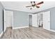 Spacious bedroom features gray walls, hardwood floors, and a ceiling fan, with a view of the bathroom at 628 Warren Ave, Scottdale, GA 30079