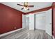 Bedroom with ceiling fan, hard surface floors, and walk in closet at 628 Warren Ave, Scottdale, GA 30079