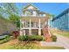 Two-story home with a quaint front porch, offering a relaxed curb appeal and an inviting entrance at 628 Warren Ave, Scottdale, GA 30079