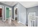 Upstairs hallway with gray walls and view into bathrooms and bedroom at 628 Warren Ave, Scottdale, GA 30079