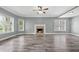 Bright, open living room with a cozy fireplace, fan, and multiple windows for natural light at 628 Warren Ave, Scottdale, GA 30079